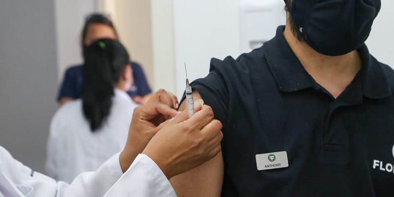 adulto sendo vacinado contra covid