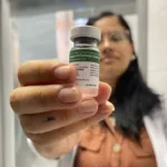 Enfermeira com a dose da vacina da gripe na mão